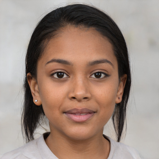 Joyful latino young-adult female with medium  brown hair and brown eyes