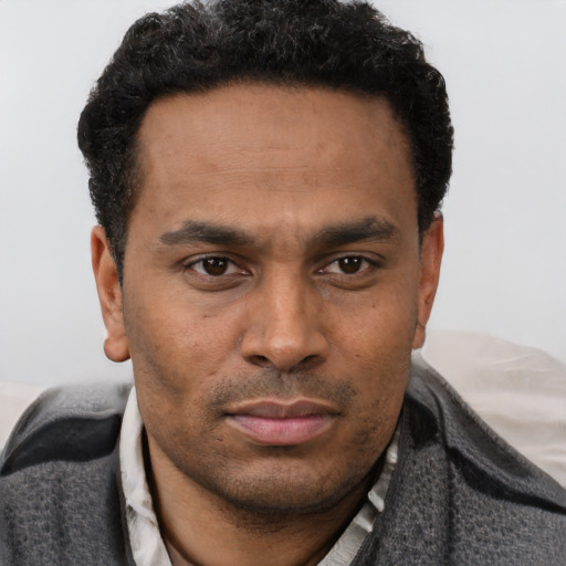Neutral latino young-adult male with short  brown hair and brown eyes