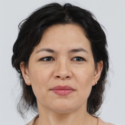 Joyful asian adult female with medium  brown hair and brown eyes