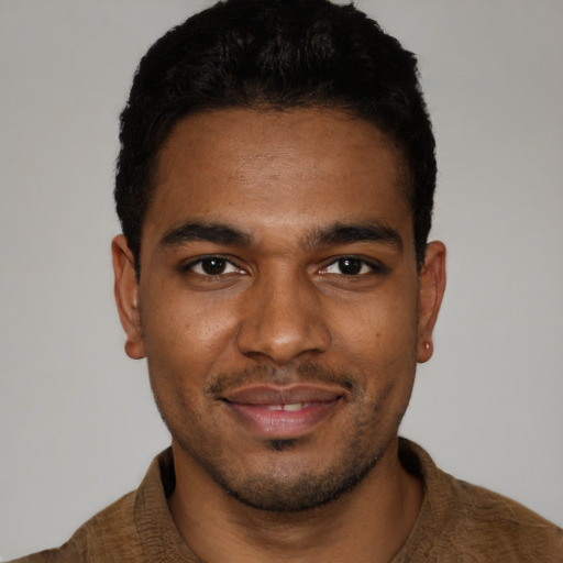 Joyful black young-adult male with short  brown hair and brown eyes