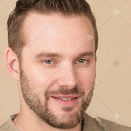 Joyful white young-adult male with short  brown hair and grey eyes