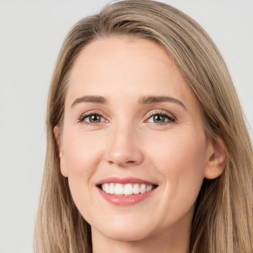 Joyful white young-adult female with long  brown hair and grey eyes