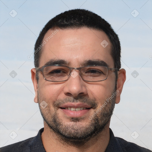 Joyful white adult male with short  black hair and brown eyes