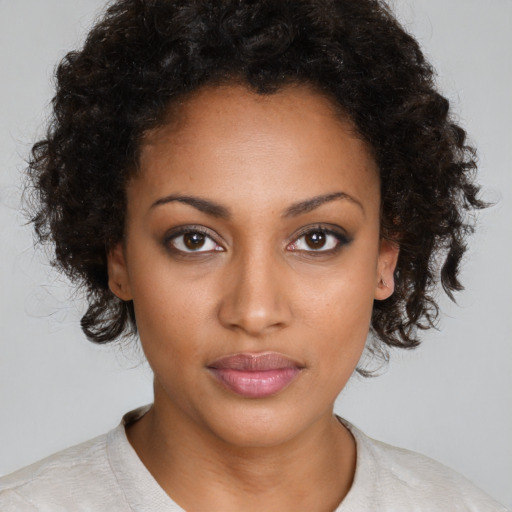 Neutral black young-adult female with medium  brown hair and brown eyes