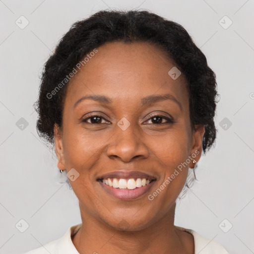 Joyful black adult female with short  brown hair and brown eyes