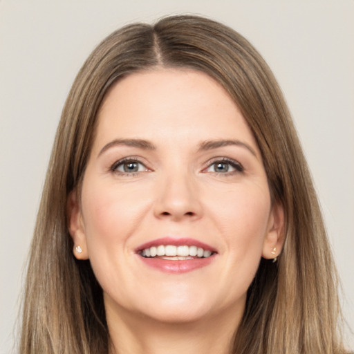 Joyful white young-adult female with long  brown hair and grey eyes