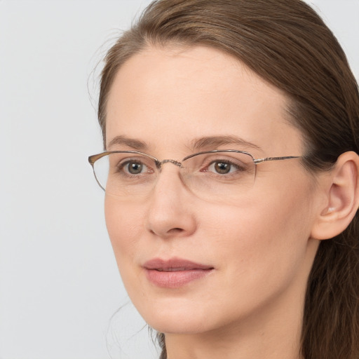 Joyful white adult female with long  brown hair and brown eyes