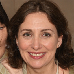 Joyful white adult female with medium  brown hair and brown eyes