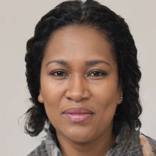 Joyful black adult female with medium  black hair and brown eyes