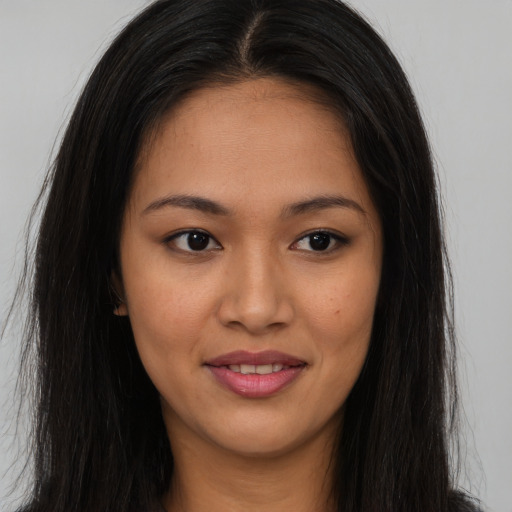 Joyful asian young-adult female with long  brown hair and brown eyes