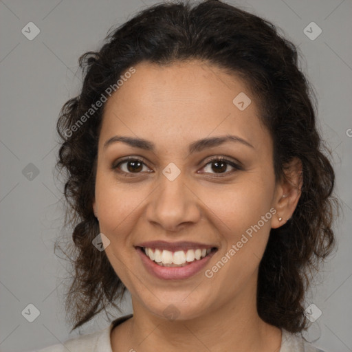 Joyful latino young-adult female with medium  brown hair and brown eyes