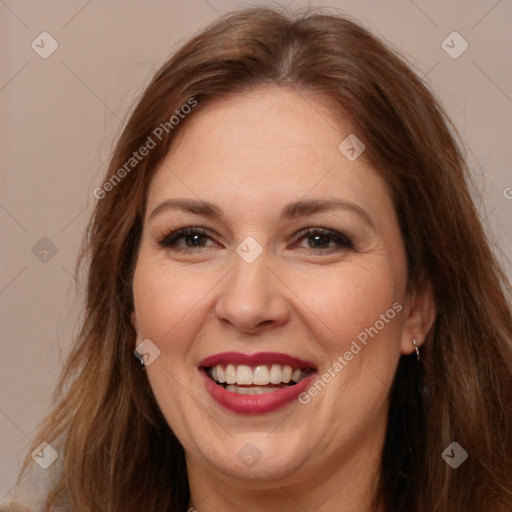 Joyful white adult female with long  brown hair and brown eyes