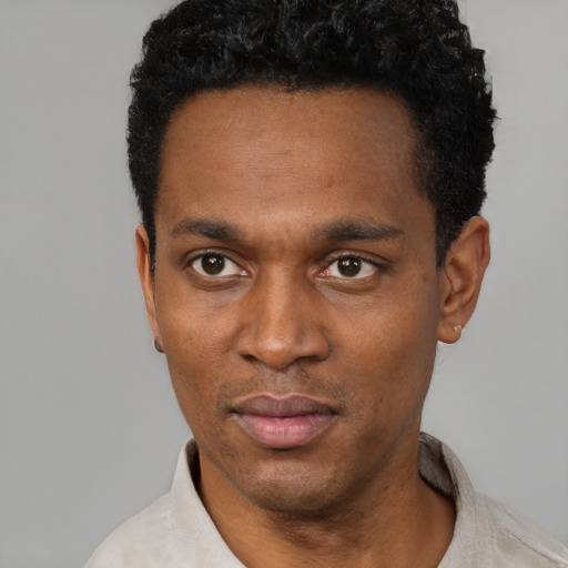 Neutral black adult male with short  black hair and brown eyes