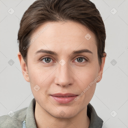 Joyful white young-adult female with short  brown hair and grey eyes