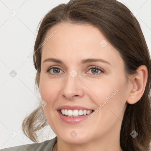 Joyful white young-adult female with medium  brown hair and grey eyes