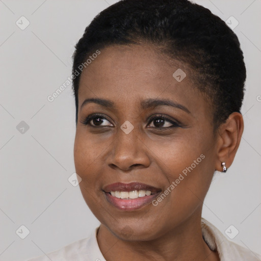 Joyful black young-adult female with short  black hair and brown eyes