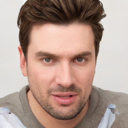 Joyful white young-adult male with short  brown hair and grey eyes