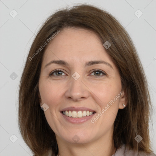 Joyful white adult female with medium  brown hair and brown eyes