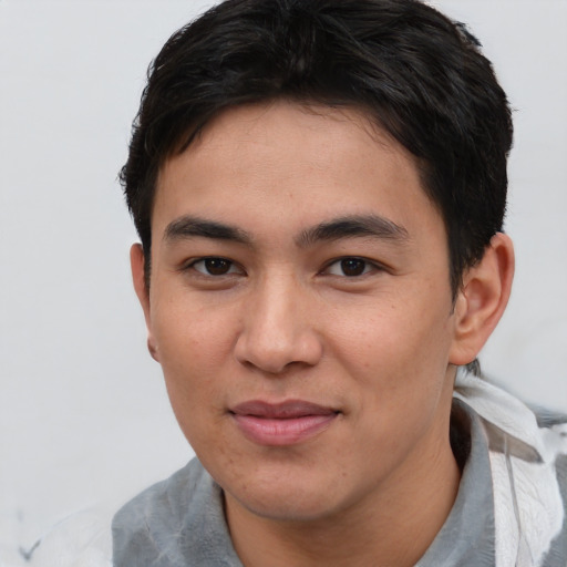 Joyful asian young-adult male with short  brown hair and brown eyes