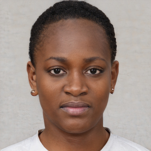 Joyful black young-adult female with short  black hair and brown eyes