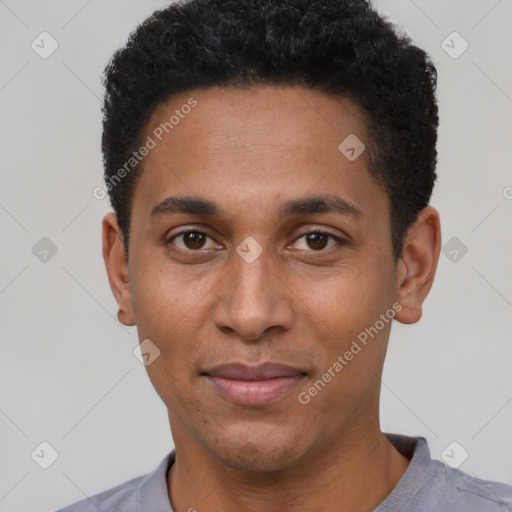 Joyful black young-adult male with short  black hair and brown eyes