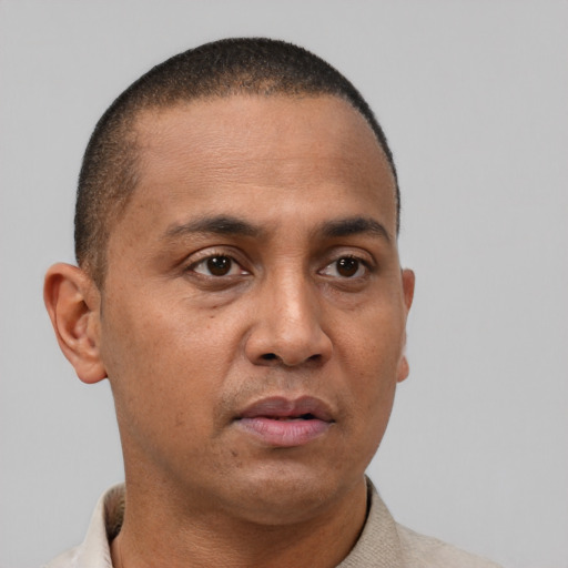 Neutral latino young-adult male with short  brown hair and brown eyes