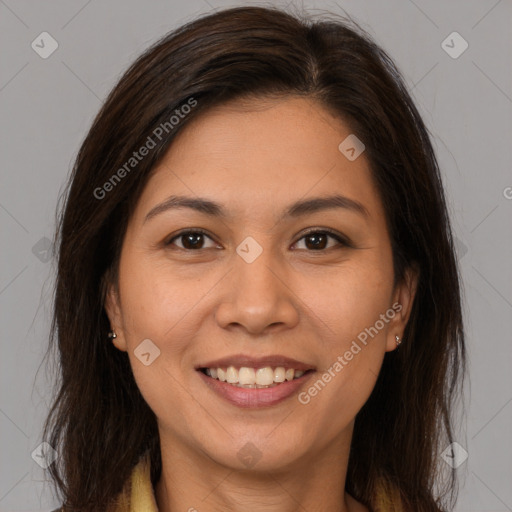 Joyful latino young-adult female with long  brown hair and brown eyes