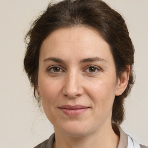 Joyful white adult female with medium  brown hair and grey eyes