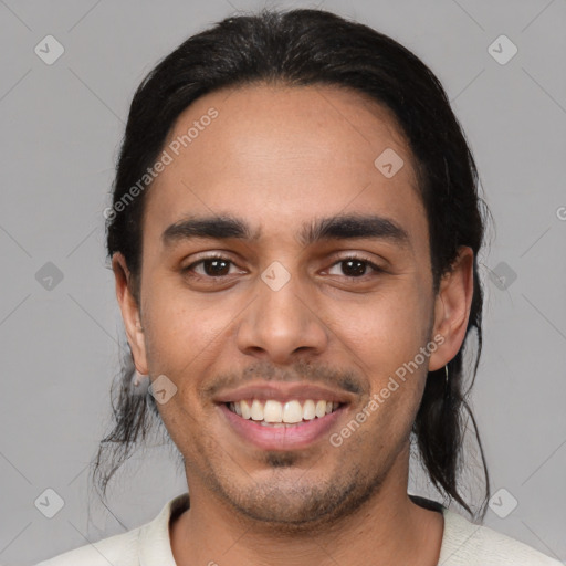 Joyful latino young-adult male with short  black hair and brown eyes