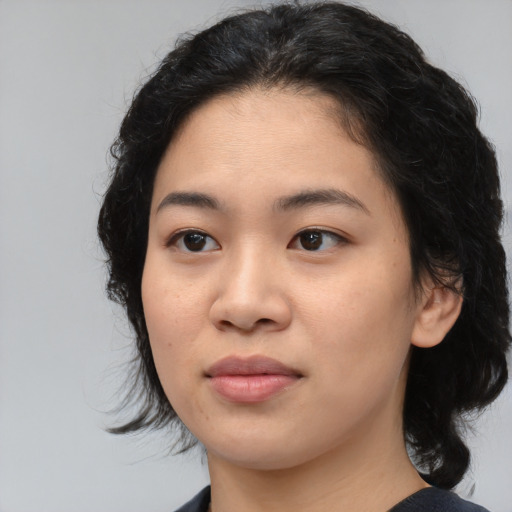 Joyful asian young-adult female with medium  black hair and brown eyes