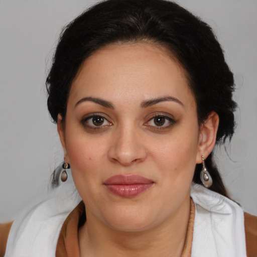 Joyful latino young-adult female with medium  brown hair and brown eyes