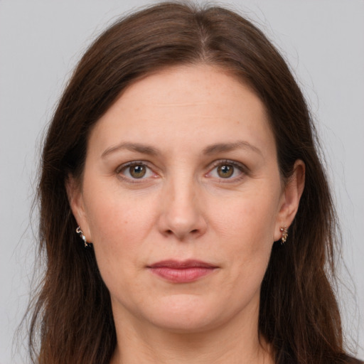 Joyful white adult female with long  brown hair and grey eyes