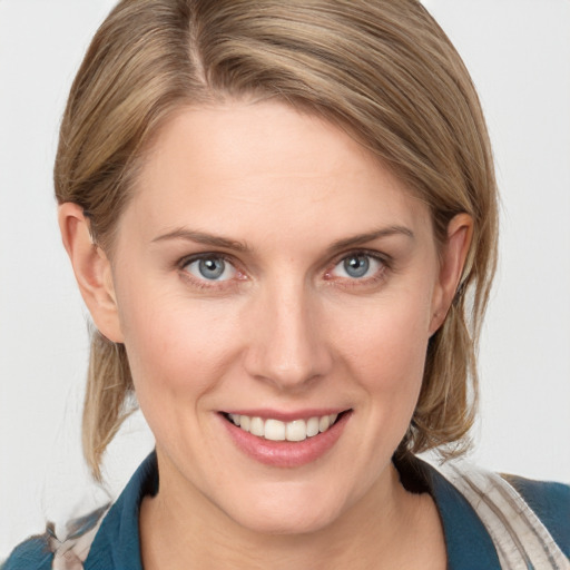 Joyful white young-adult female with medium  brown hair and blue eyes