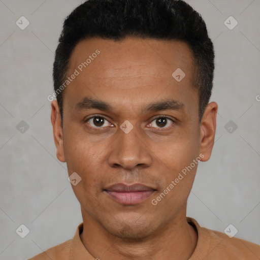 Joyful black young-adult male with short  black hair and brown eyes