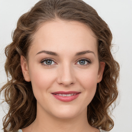 Joyful white young-adult female with long  brown hair and green eyes