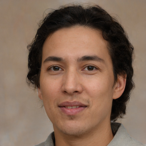 Joyful white adult male with medium  brown hair and brown eyes