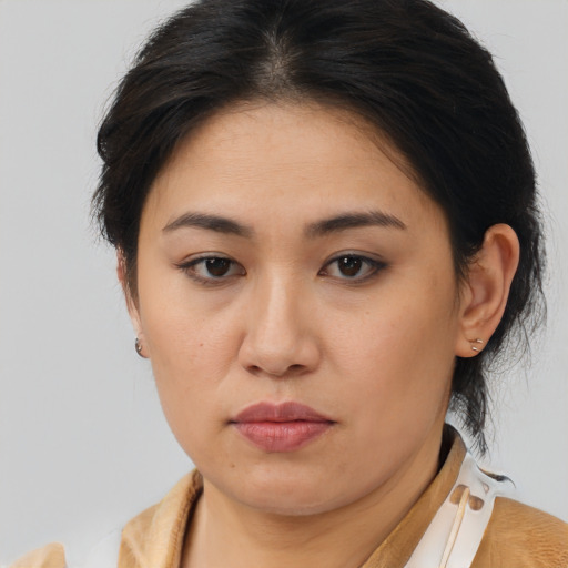 Joyful asian young-adult female with medium  brown hair and brown eyes