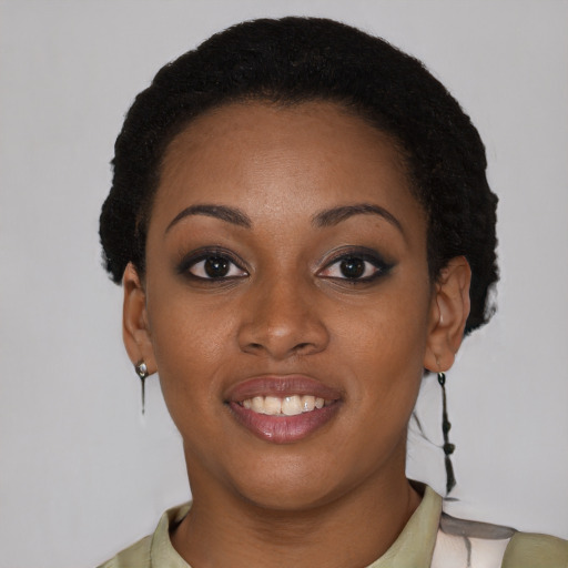 Joyful black young-adult female with short  brown hair and brown eyes