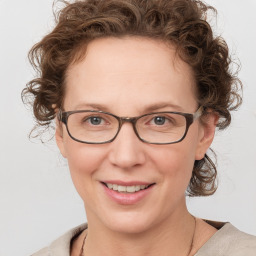 Joyful white adult female with medium  brown hair and blue eyes