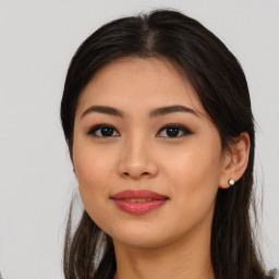 Joyful asian young-adult female with long  brown hair and brown eyes