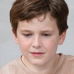 Joyful white child male with short  brown hair and grey eyes