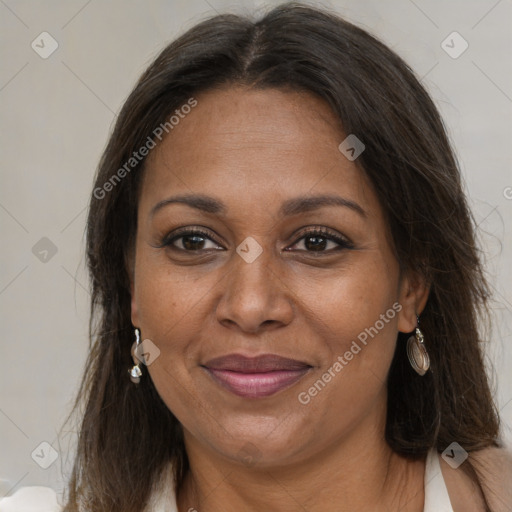 Joyful black adult female with long  brown hair and brown eyes