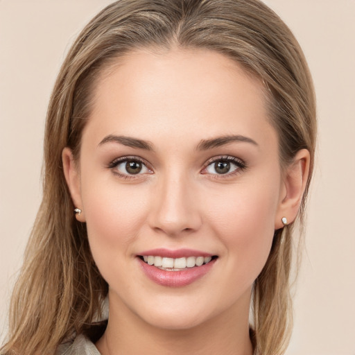 Joyful white young-adult female with long  brown hair and brown eyes