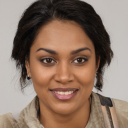 Joyful latino young-adult female with medium  brown hair and brown eyes