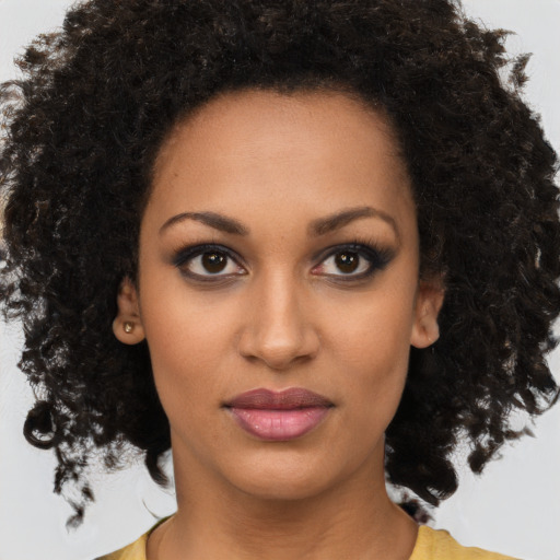 Joyful black young-adult female with medium  brown hair and brown eyes
