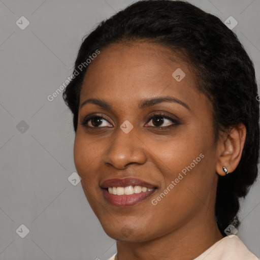 Joyful black young-adult female with short  black hair and brown eyes