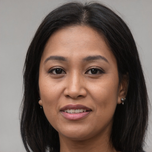 Joyful asian young-adult female with long  brown hair and brown eyes