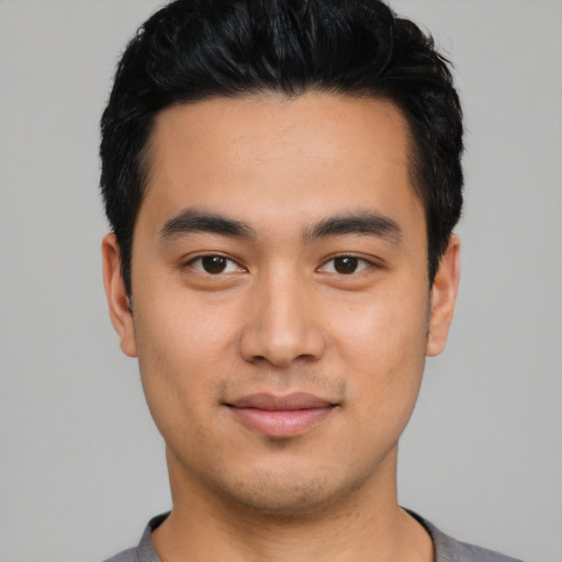 Joyful asian young-adult male with short  black hair and brown eyes