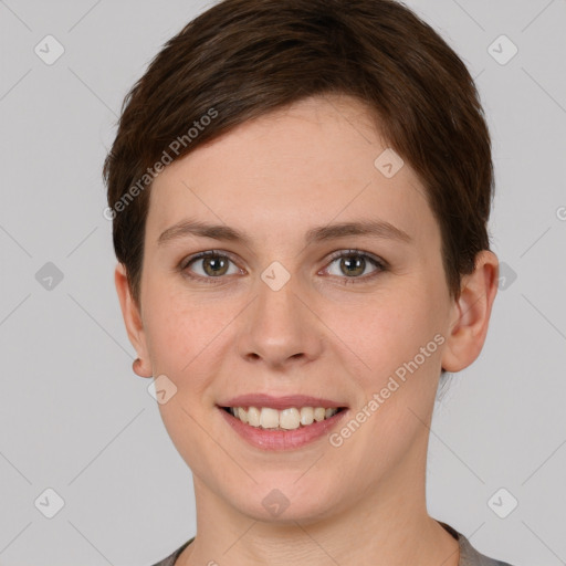 Joyful white young-adult female with short  brown hair and grey eyes