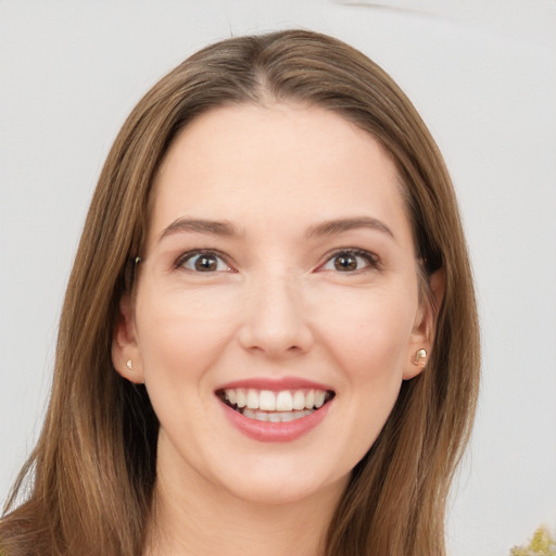 Joyful white young-adult female with long  brown hair and brown eyes